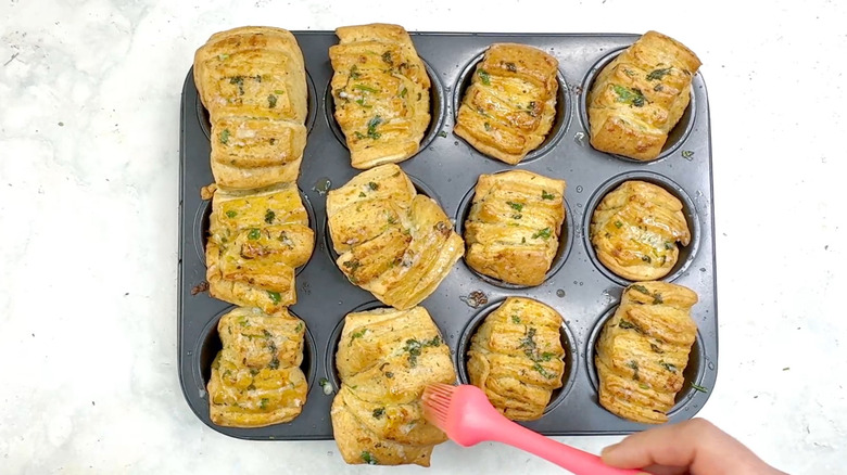 brushing fan rolls with garlic butter