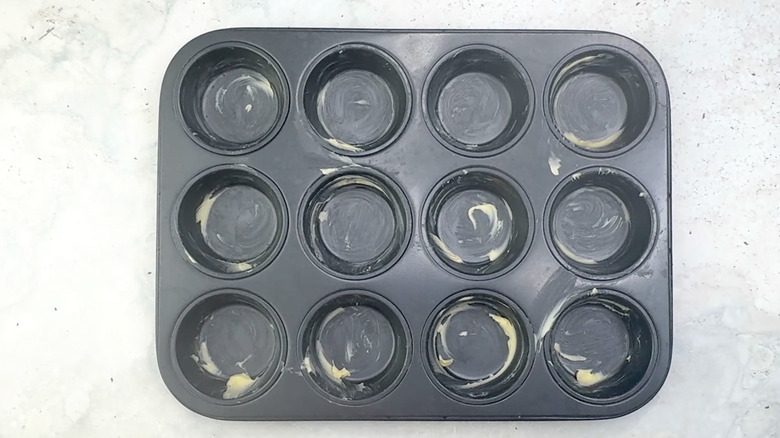 greased muffin tin