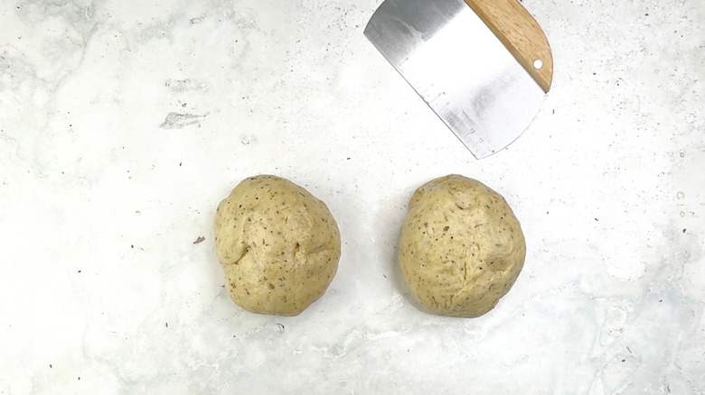 two bread raw bread dough balls on counter