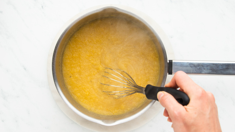 Whisking polenta in saucepan