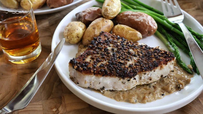 swordfish au poivre with potatoes and asparagus