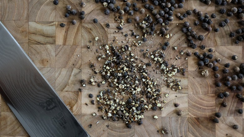 crushed peppercorns on cutting board