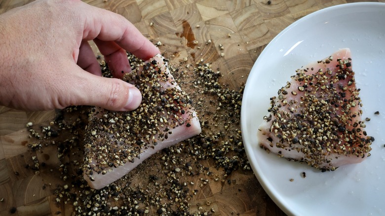 coating swordfish with coarse pepper