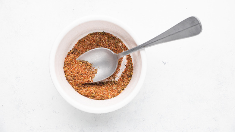 Mixing spices in bowl with spoon