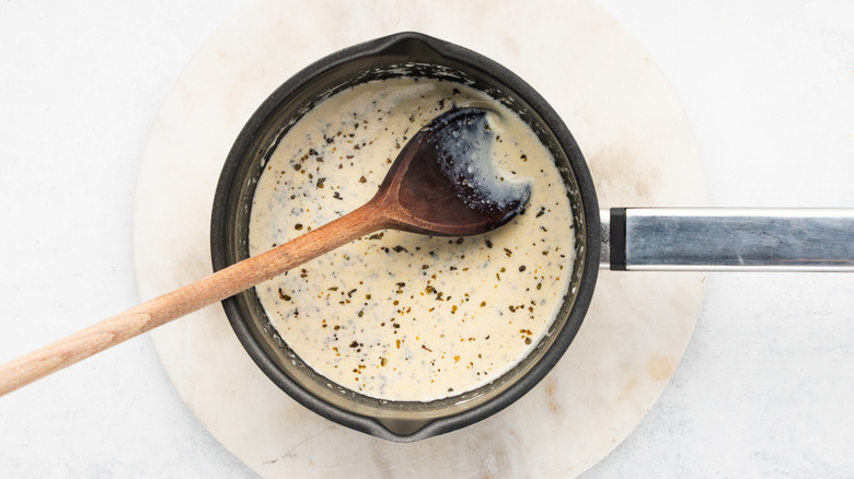 Making Alfredo sauce in pan