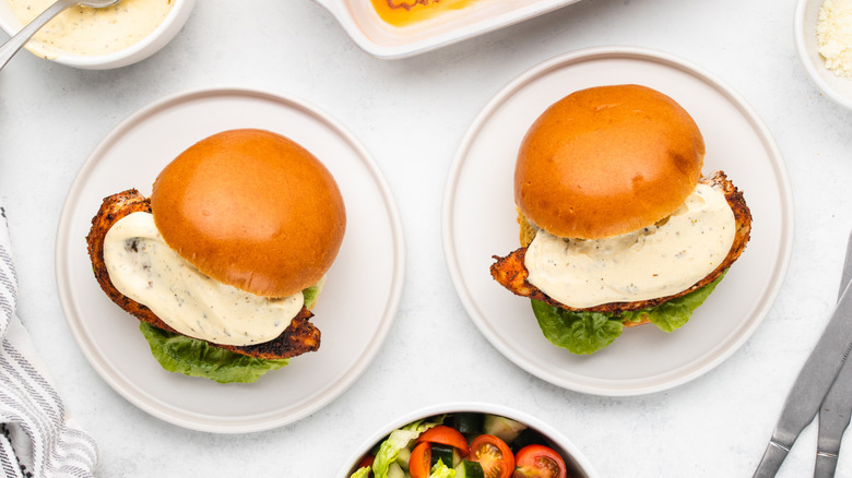 Two Cajun chicken Alfredo sandwiches on plates