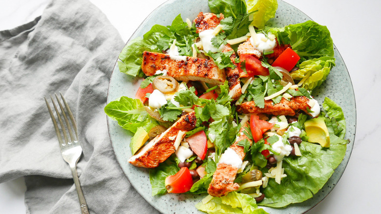 Chicken salad on plate with napkin and form