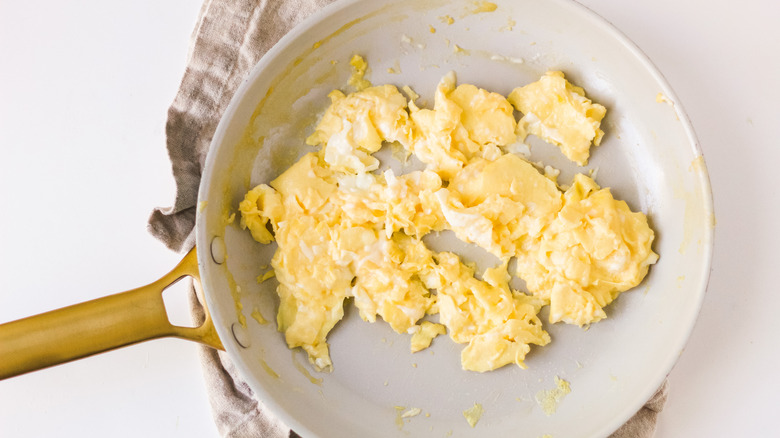 eggs lightly scrambled in a pan