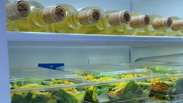 a fridge full of wine and salads