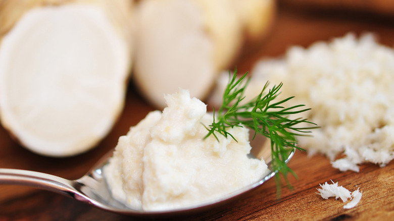 grated horseradish in a spoon garnished with dill