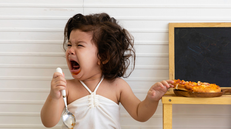 Girl crying with spicy food