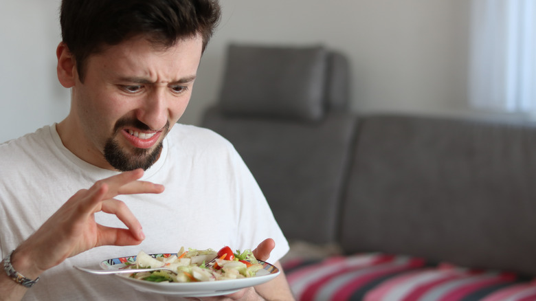 Man finding hair in salad 