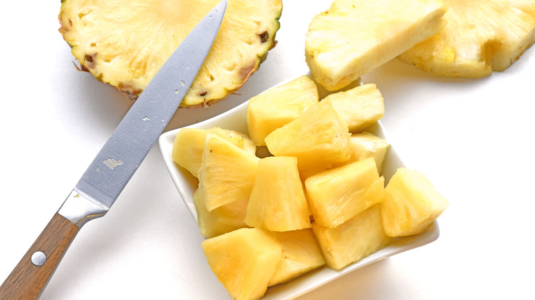 cut pineapple with knife