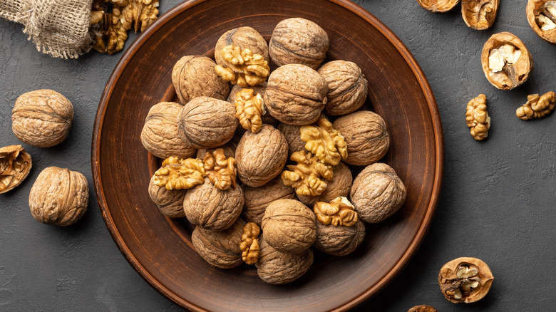 Shelled walnuts in brown bowl