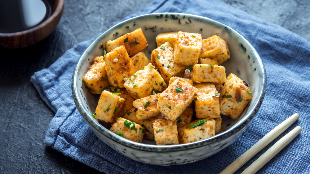 Cooked tofu in a bowl with napkin