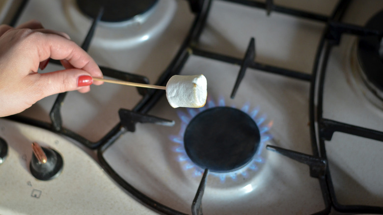 Roasting marshmallow over gas stove