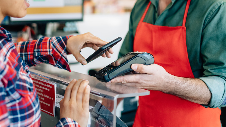 Customer paying with phone at checkout