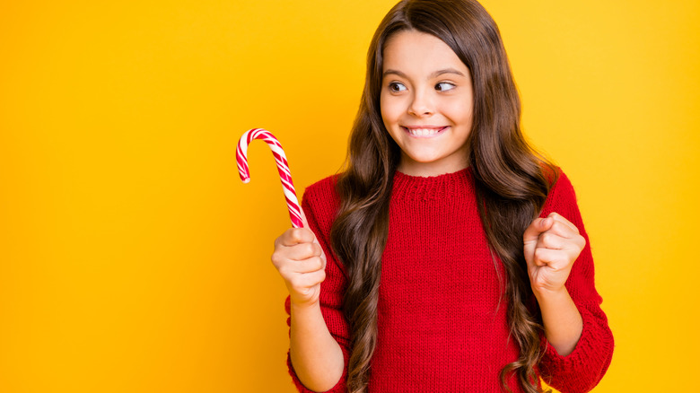 girl excited about candy canes