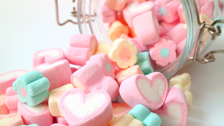 heart-shaped candies spilling out of a jar