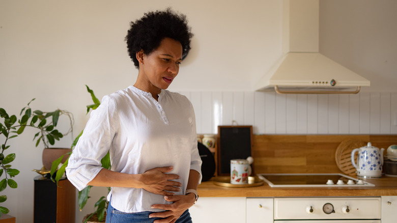 woman holding stomach