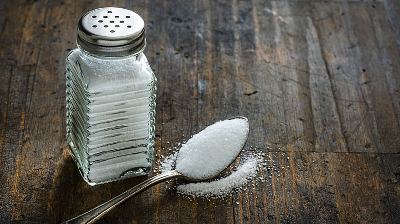 salt shaker and spoon with salt