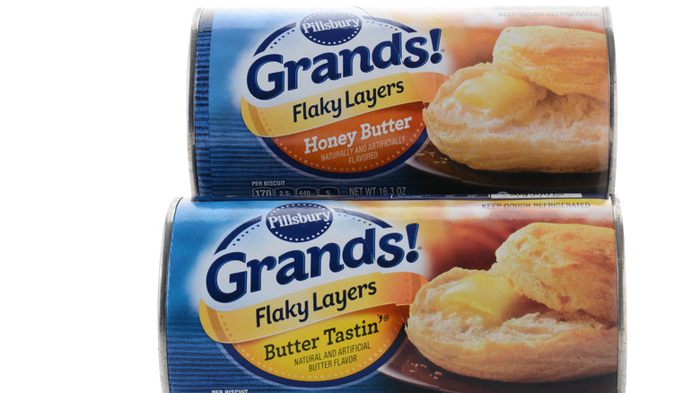 Two cans of pillsbury biscuits in different flavors