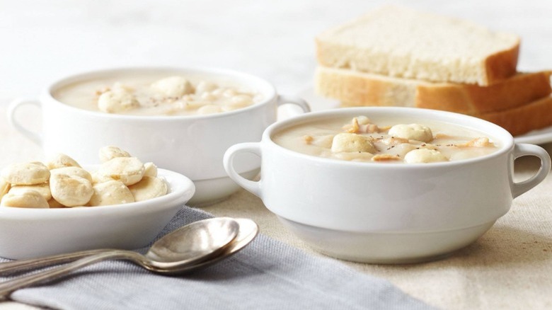 Bowl  Clam Chowder on table with bread and crackers