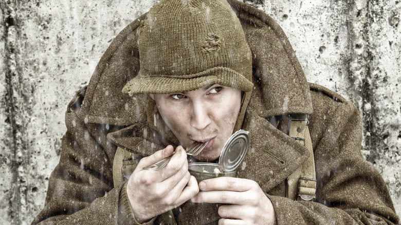 soldier eats from can