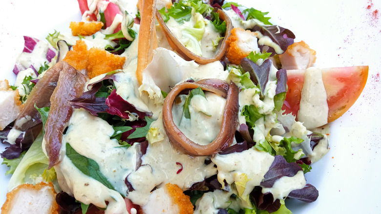 Anchovies with salad and chopped fried chicken