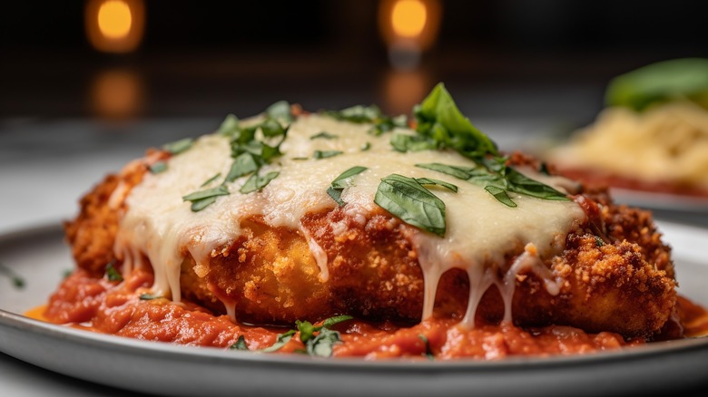 Fried chicken with tomatoes and melted cheese