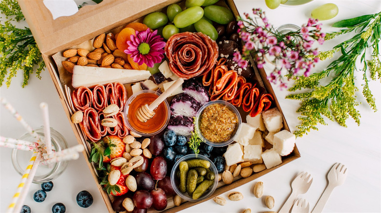 healthy charcuterie board layout with flowers