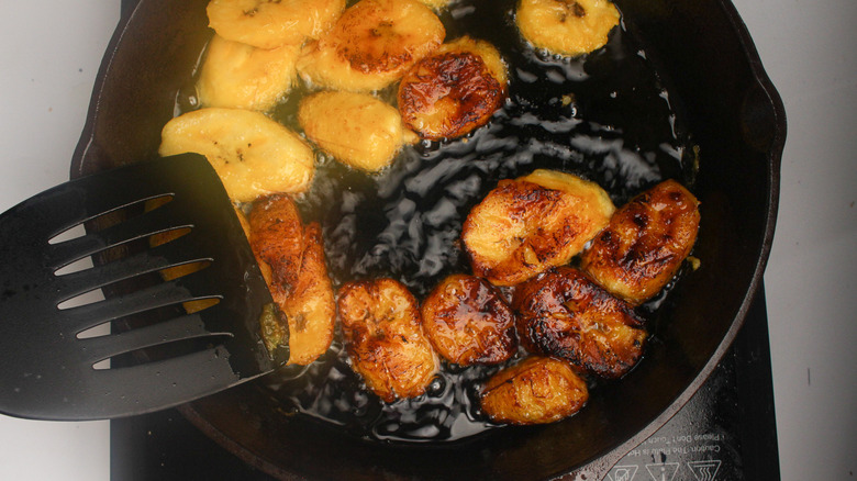 plantain slices frying in pan