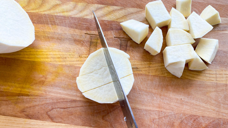 knife cutting through yam