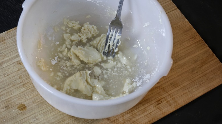 mashing cream cheese with fork