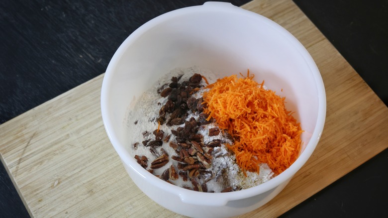 bowl of flour, raisins, and grated carrot