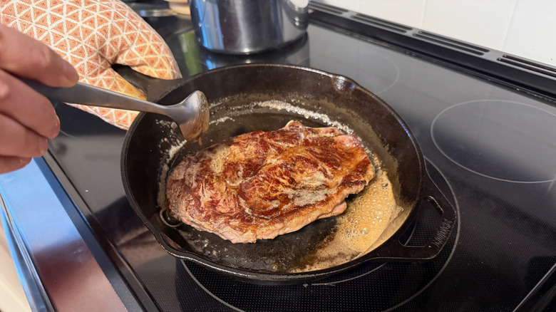 basting steak in cast-iron pan