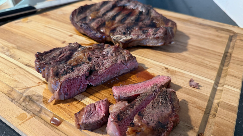 sliced steak on cutting board