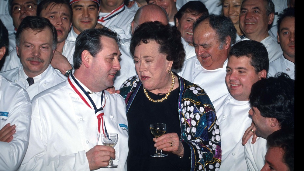 Julia Child surrounded by chefs