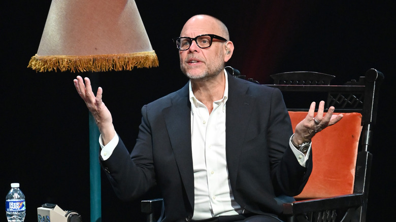 Alton Brown sitting on stage