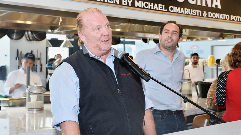 Mario Batali talks into a mic