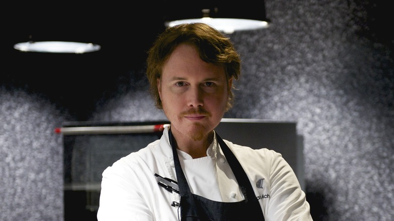 Chef Grant Achatz in spotlit kitchen