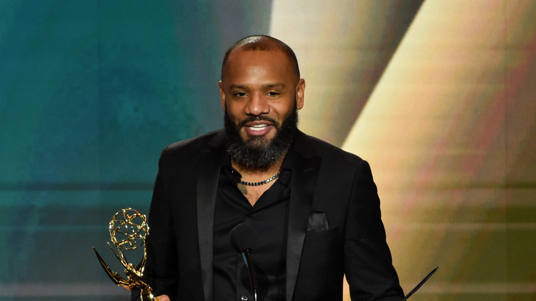 Chef Justin Sutherland holding Emmy Award