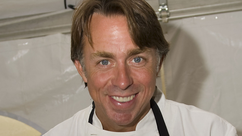 John Besh in chef whites and black apron