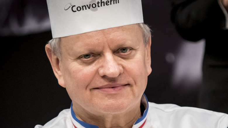 Joël Robuchon wears hat and French chef's coat