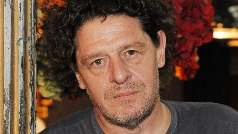 Marco Pierre White leaning against a pillar