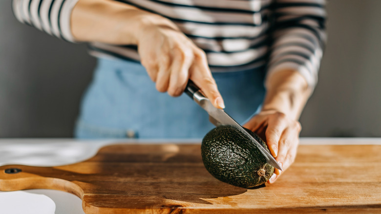 Chef cutting avocado