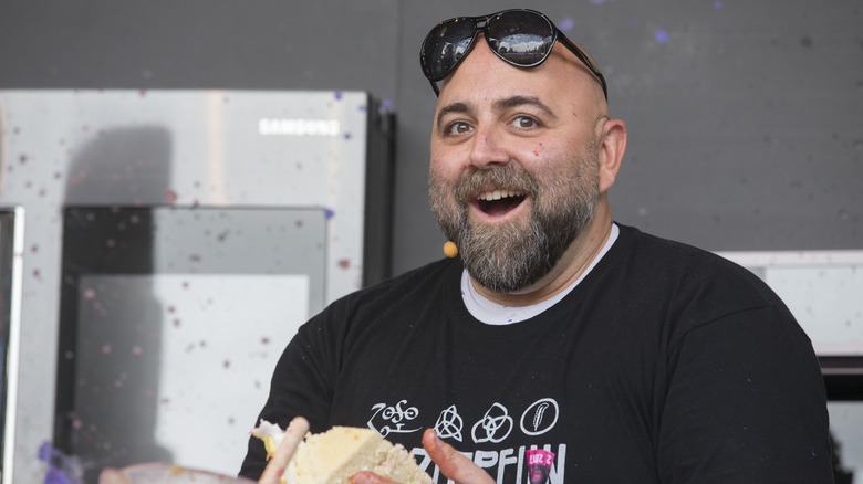 Duff Goldman holding cake slice