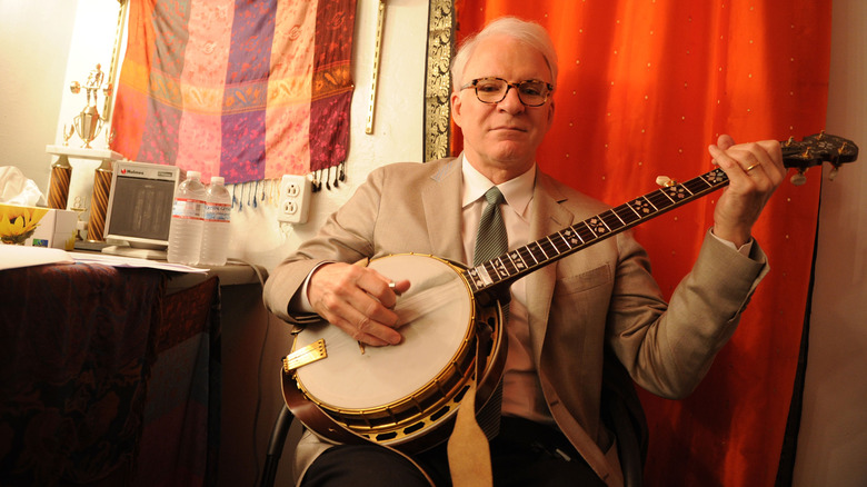 Steve Martin holding a banjo