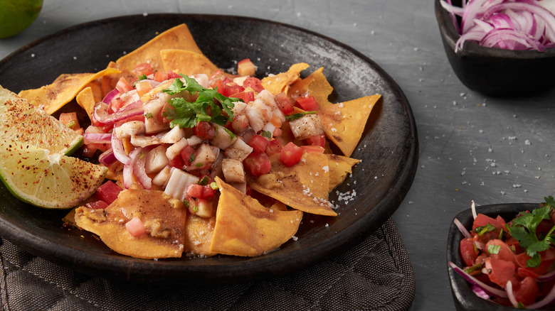 ceviche nacho plate with lime wedges