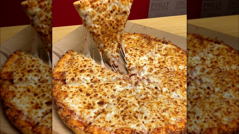 Dominos cheesy pizza in a box